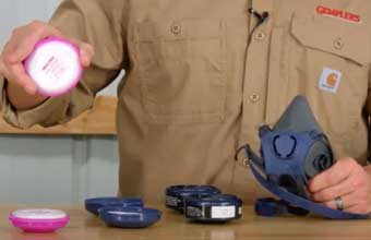 Man demonstrating how to attach respirator cartridge