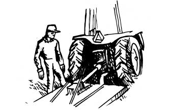 Person inspecting tractor hook up to equipment