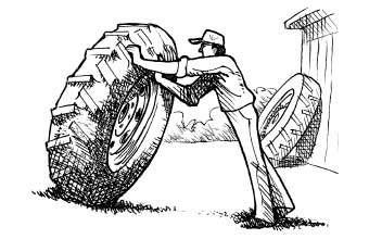 Man moving a loose tractor tire