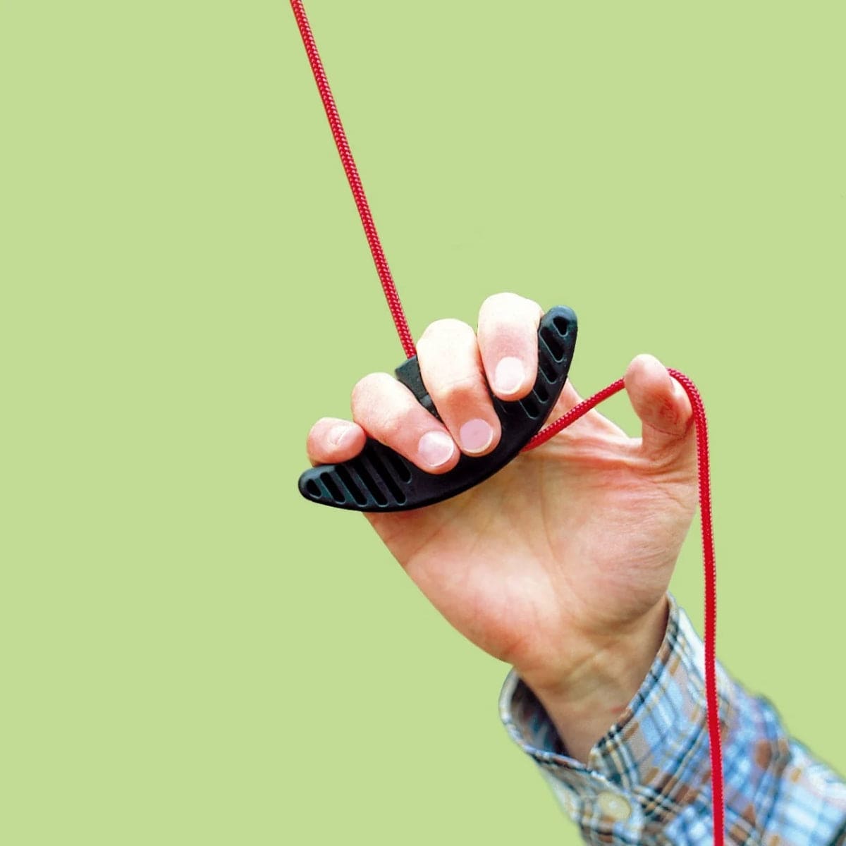 WOLF-Garten pulley system for tree lopper. Hand holding black pulley mechanism.