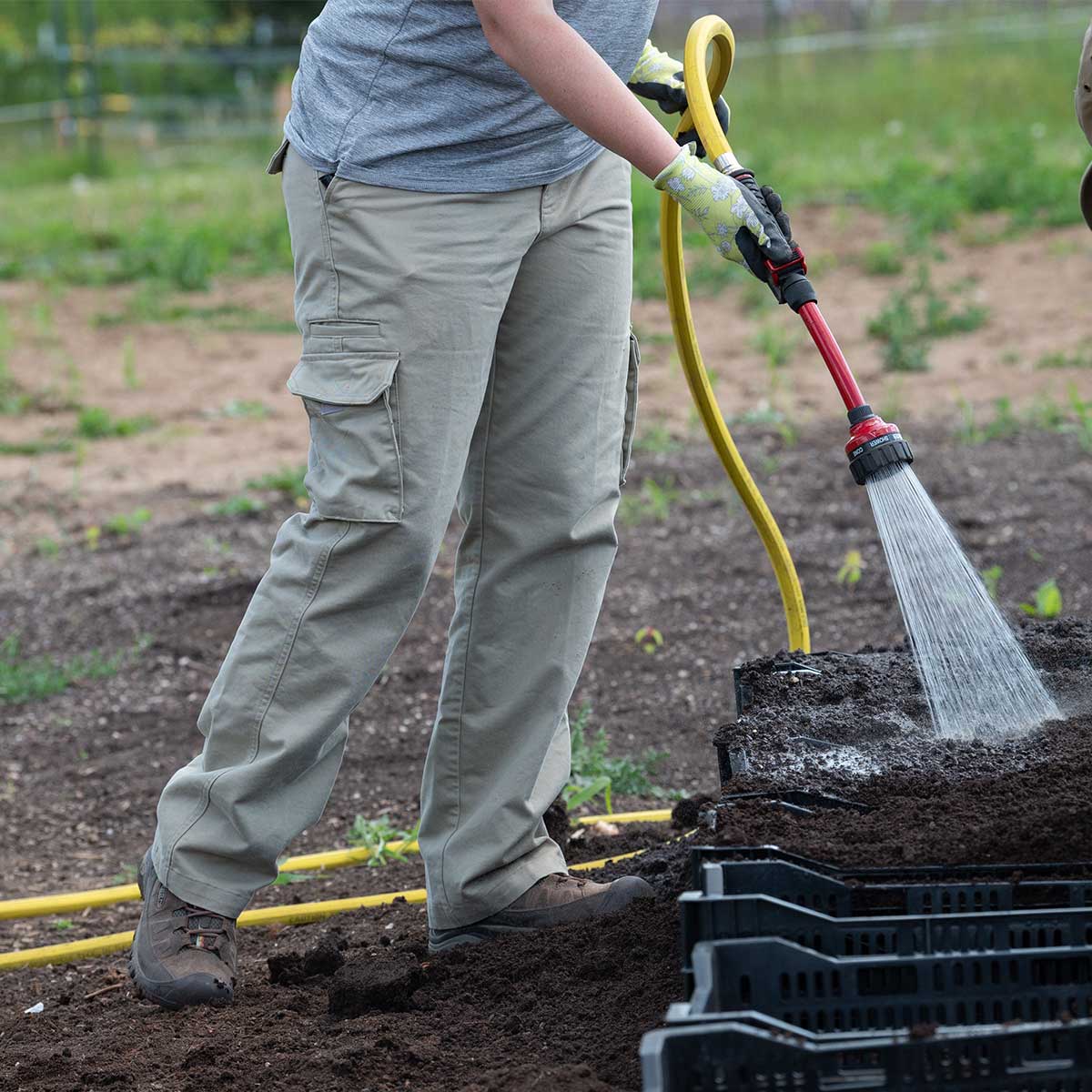 Professional greenhouse using Dramm professional hose to water seedlings.
