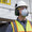 Man wearing hard hat with earmuff attachments, safety glasses, and Moldex 2300 respirator