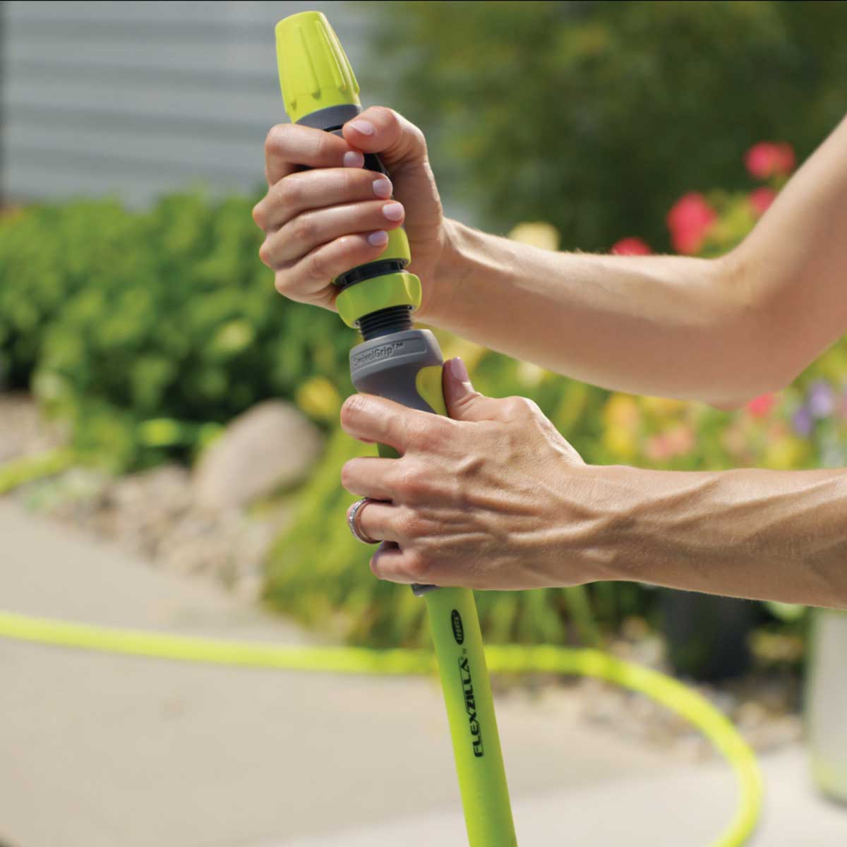Flexzilla water hose being connected to a professional nozzle.