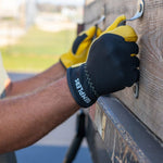 Gemplers Leather Palm Hybrid Work Gloves with Elastic Cuff in use about to pull off shovels and rakes off a landscaper truck