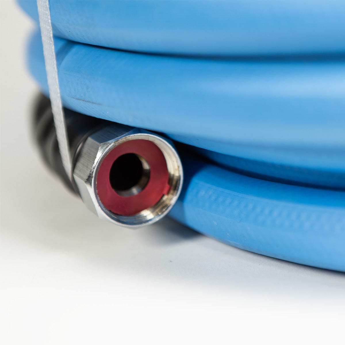 Close up view of durable brass ends on professional-grade water hose.