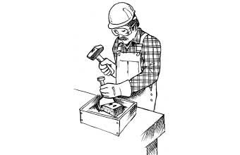 Person using hand tool to cut brick while wearing gloves, goggles and hard hat