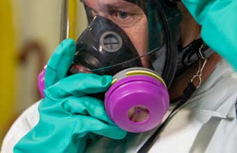 Man donning a full-face respirator