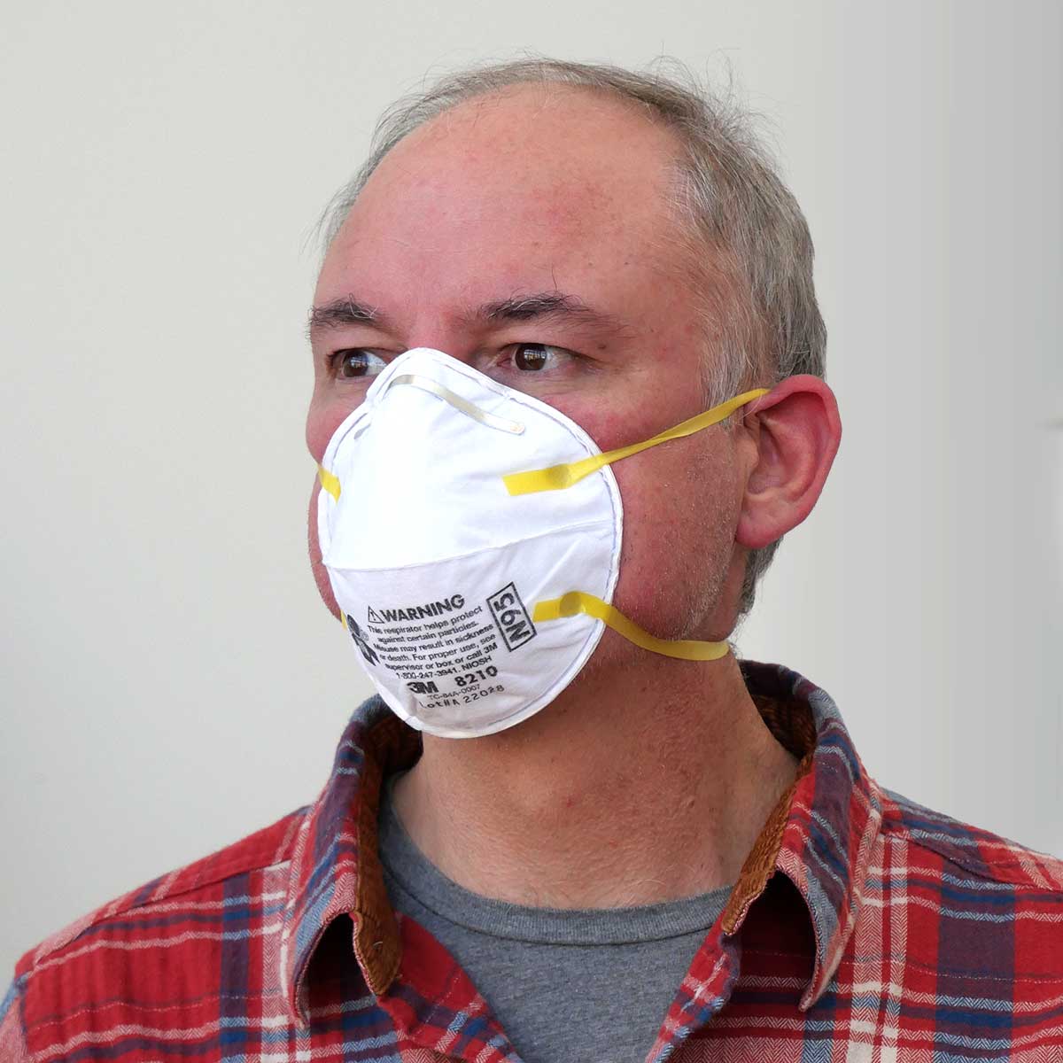 Person wearing a 3M 8210 Particulate Respirator