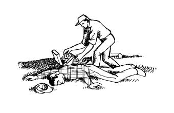 Person administering first aid to person passed out in field