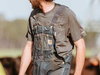 Worker in bib overalls and t-shirt