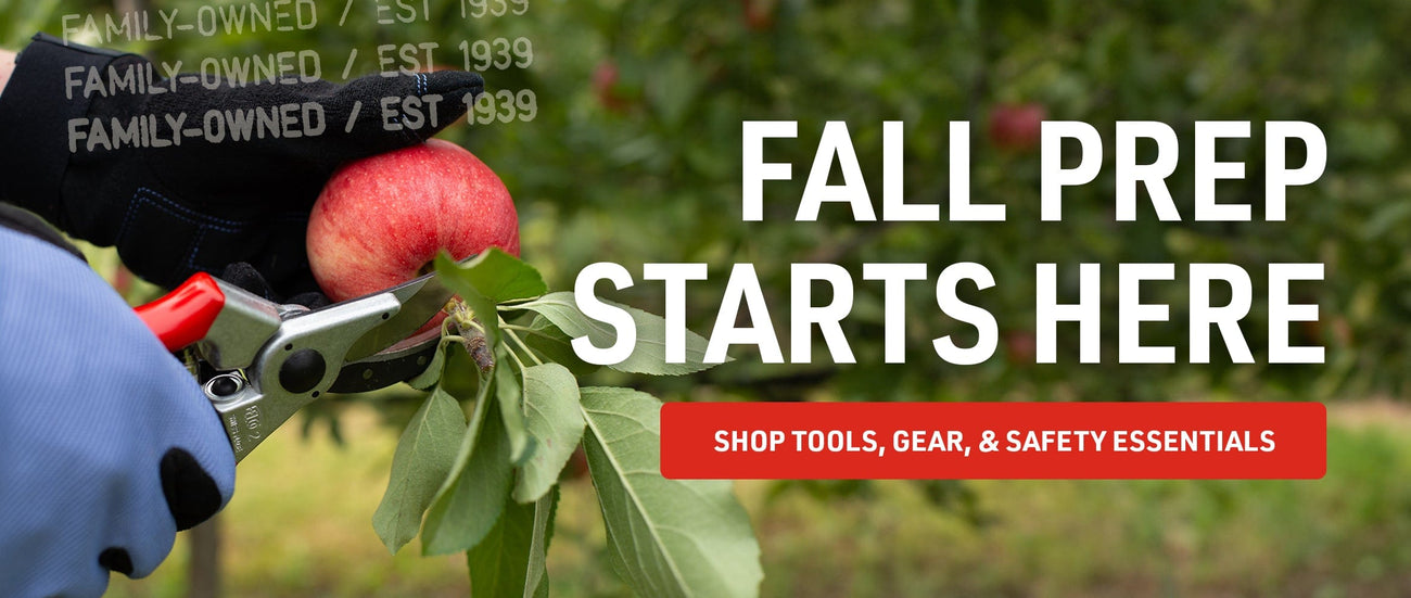 Person wearing coated work gloves using FELCO bypass pruners to cut a branch with a red apple in an orchard with banner text promoting fall prep tools.