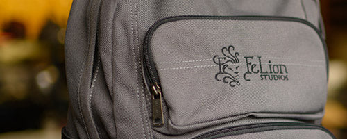 Embroidered logo on gray backpack