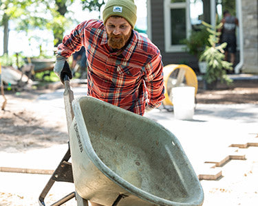 Man pushing a wheelbarrow
