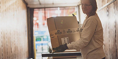 Woman loading packages in a truck