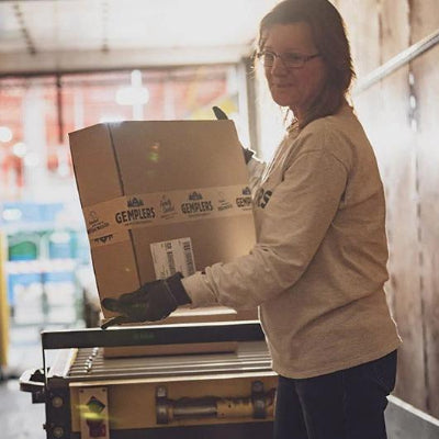 Woman loading freight in a truck bay