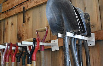 Metal tool racks with hanging shovels