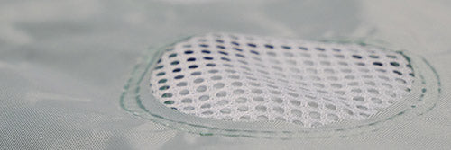 Material with a mesh-filled cutout vent