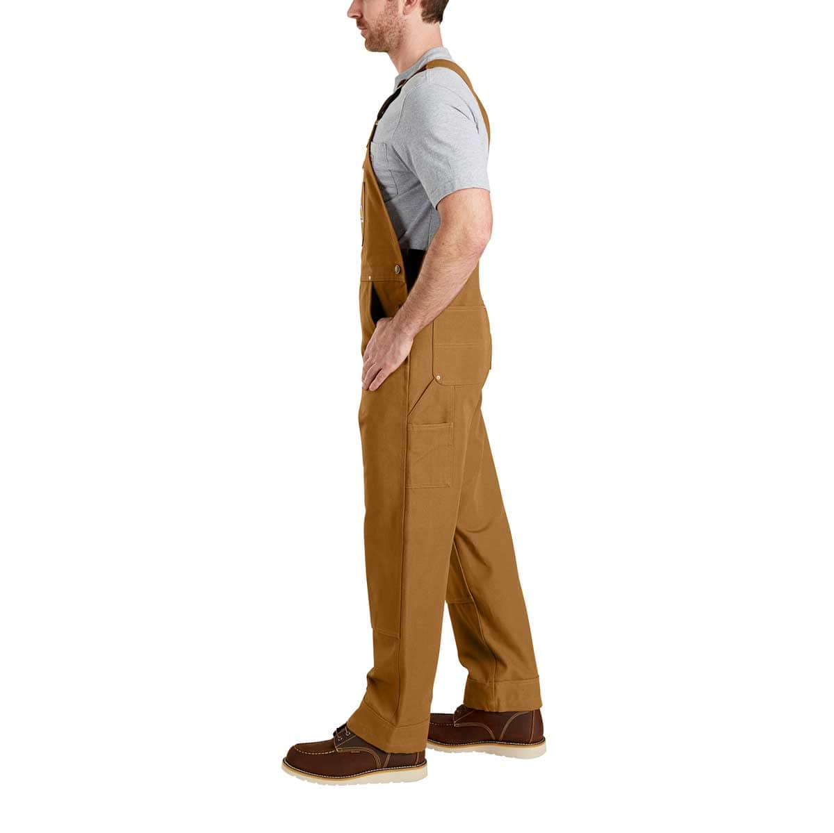 Left side of Carhartt Men's Duck Bib Overall - Brown on model
