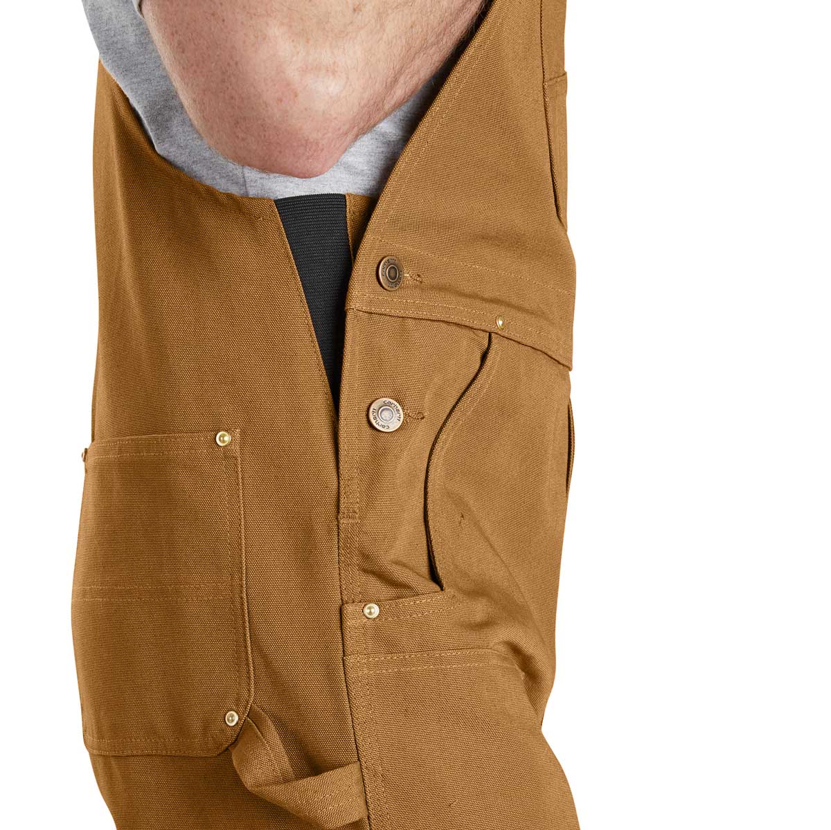 Right side of Carhartt Men's Duck Bib Overall - Brown on model