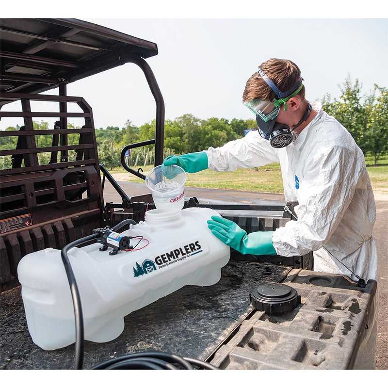 Man by a sprayer wearing safety equipment