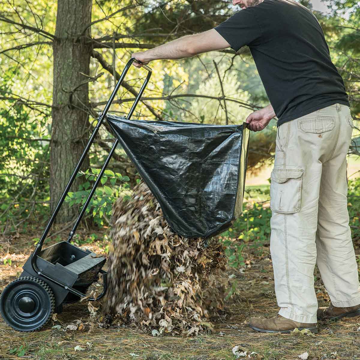 Dumping the hopper of the Agri-Fab 26" Push Lawn Sweeper